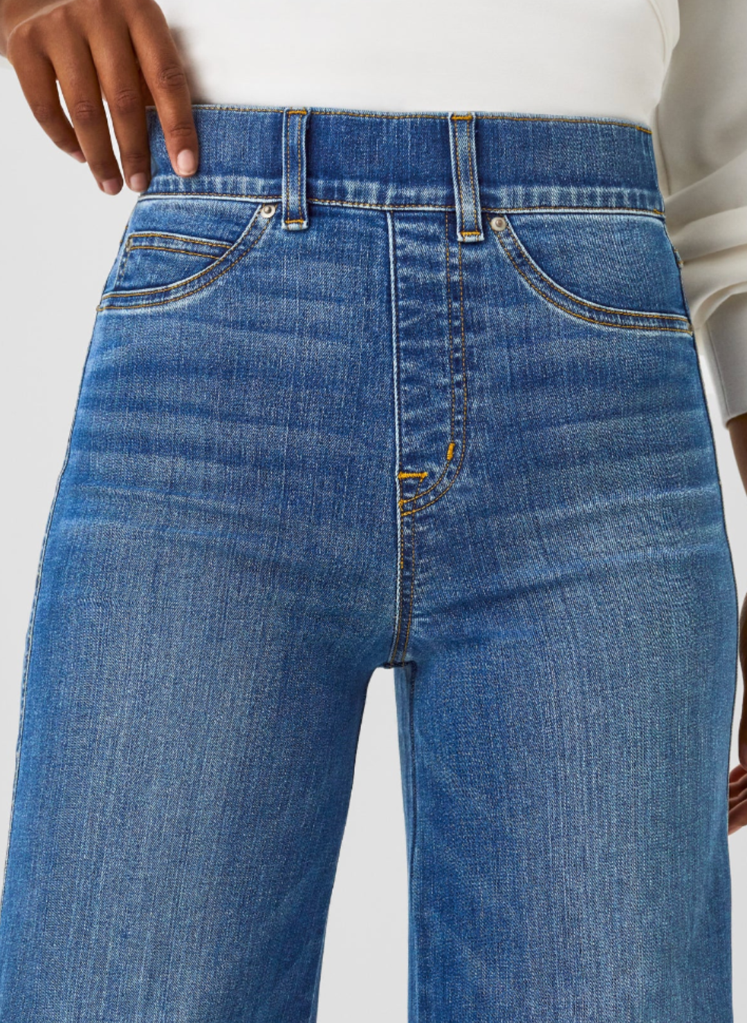 Front close up view of the elastic waist line in the SPANX Ocean Flare Jeans