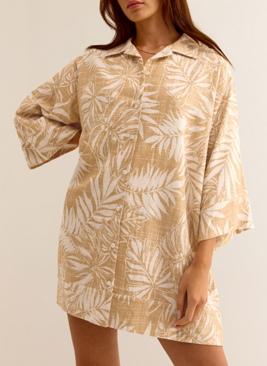 Model wearing golden Palm Dress with front buttons, 3/4 sleeves, and collared neckline.