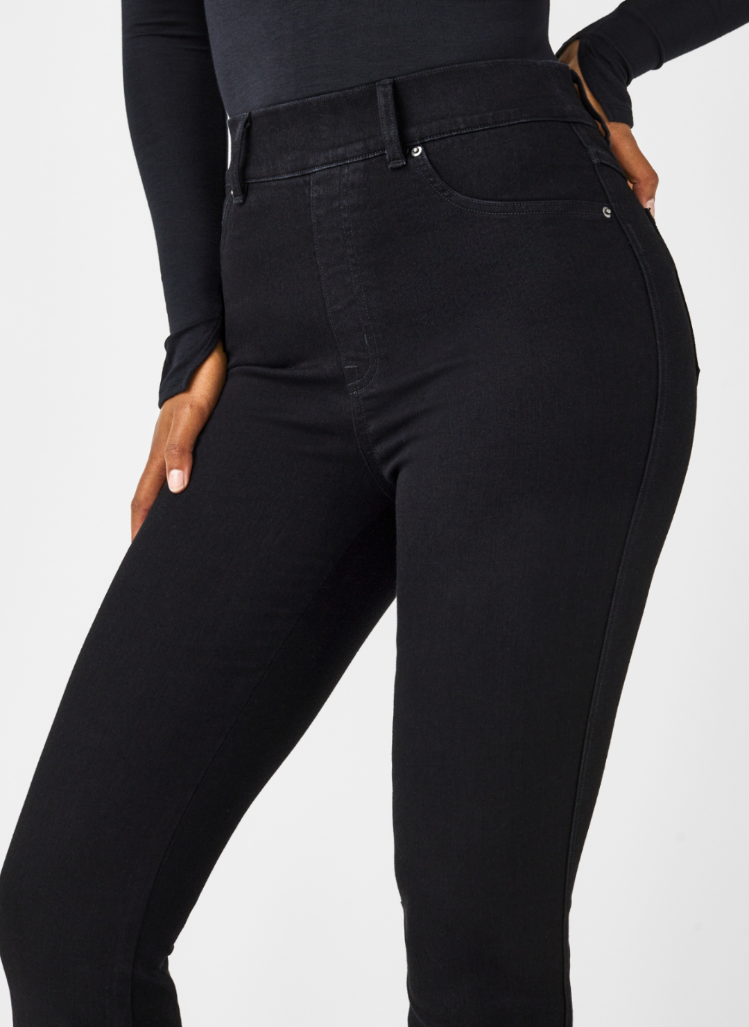 Close up front view of SPANX black denim jeans.