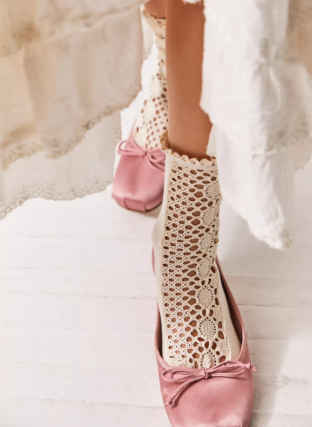 Up close view of model wearing the Free People Rubies Crochet Socks. Model is wearing pink shoes.