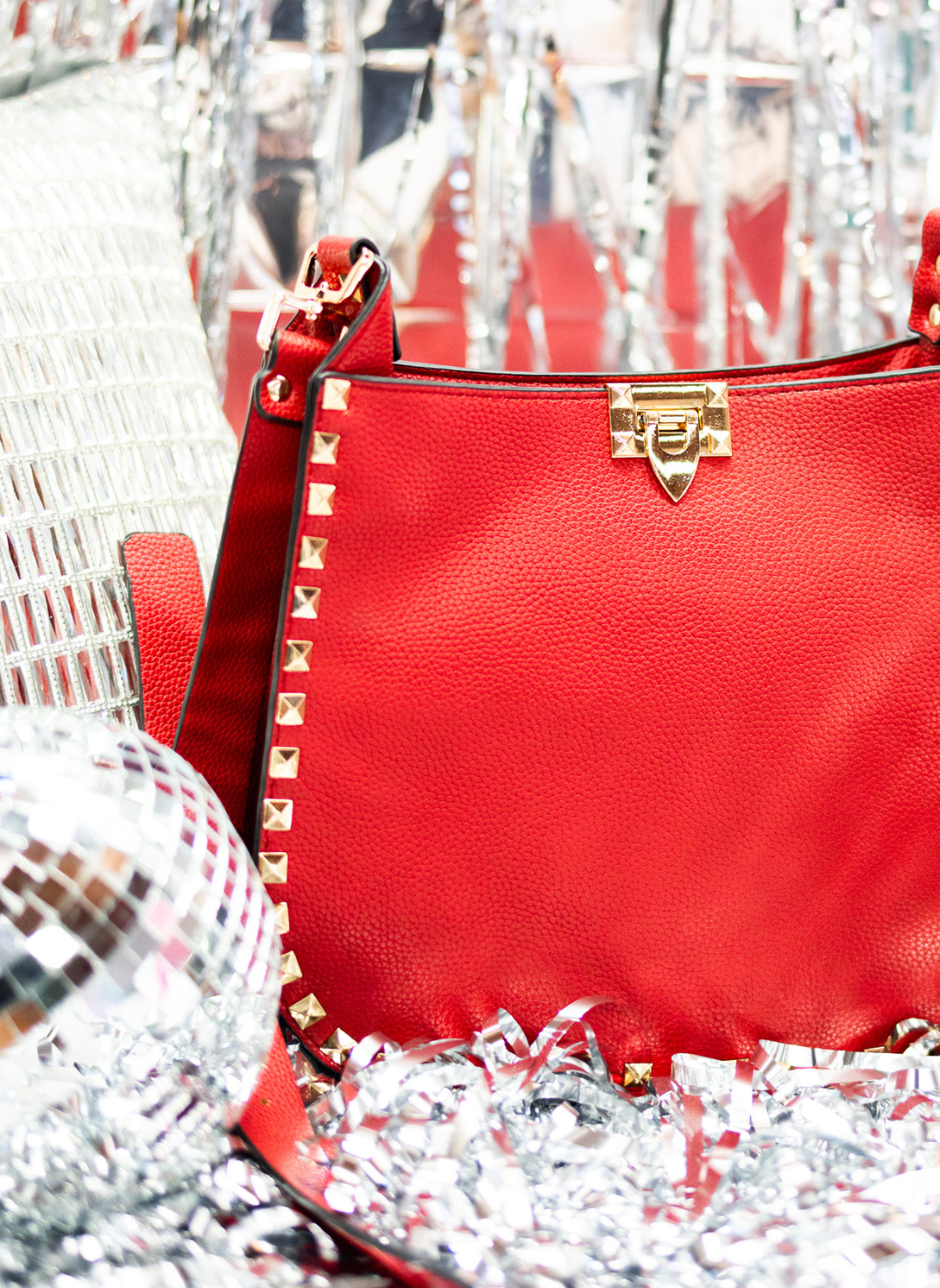 Image showing an up close view of the Red - The D'Vil Stud Bag.