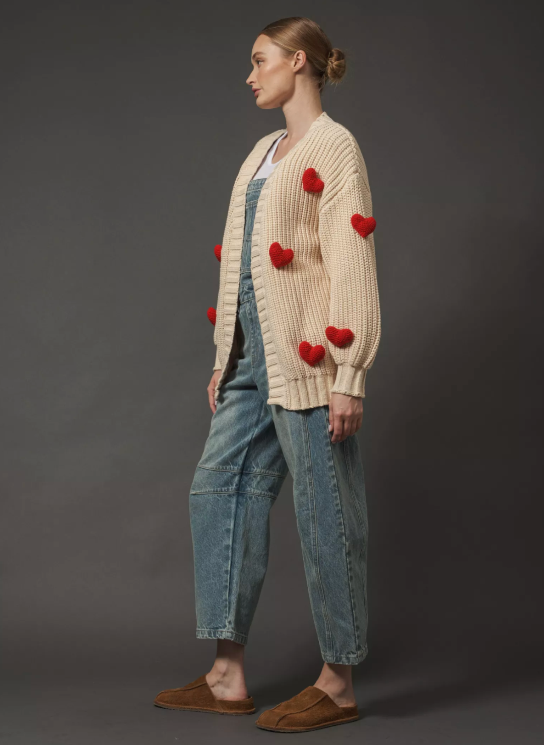 Model is turned to the side showing the side view of the Big love Cardigan