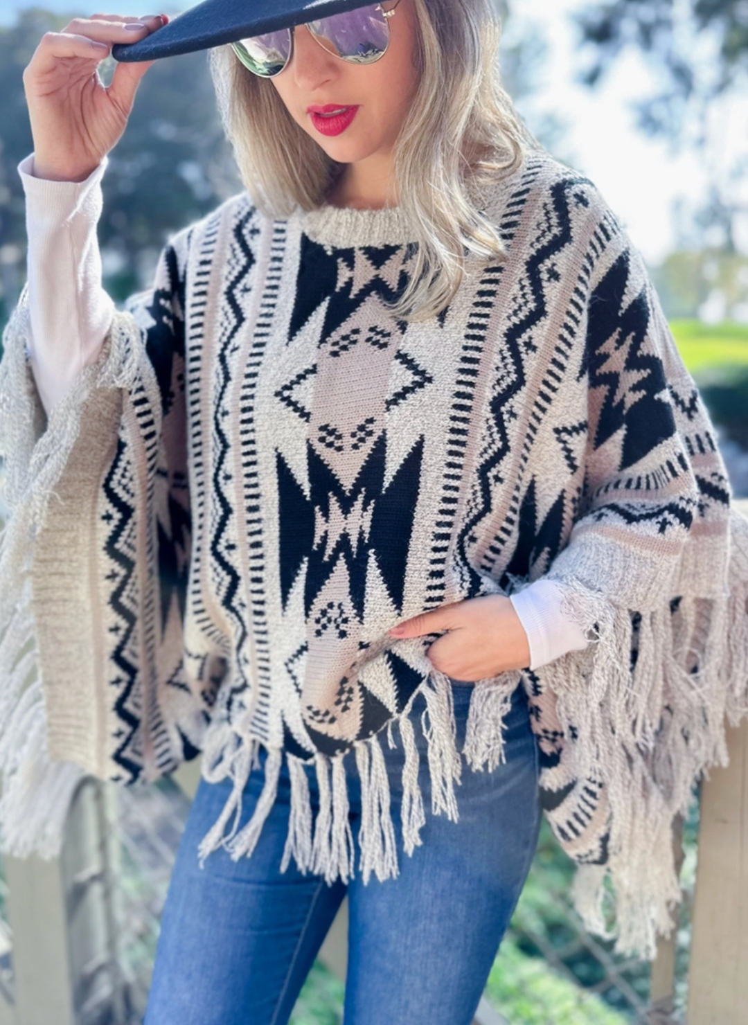 Front view of model wearing Prairie Moon Knit Tassel Top.