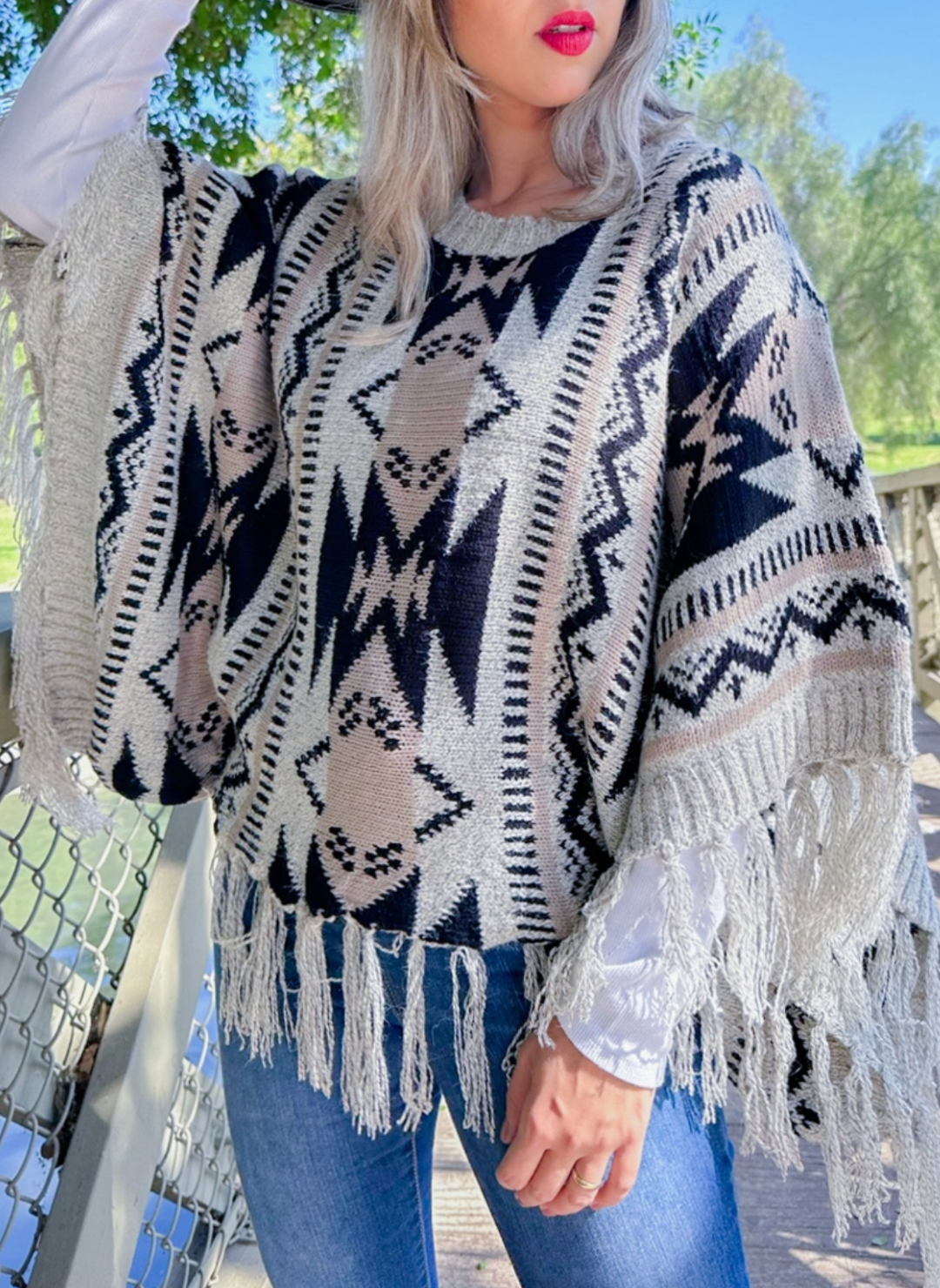 Front view of model wearing Prairie Moon Knit Tassel Top.