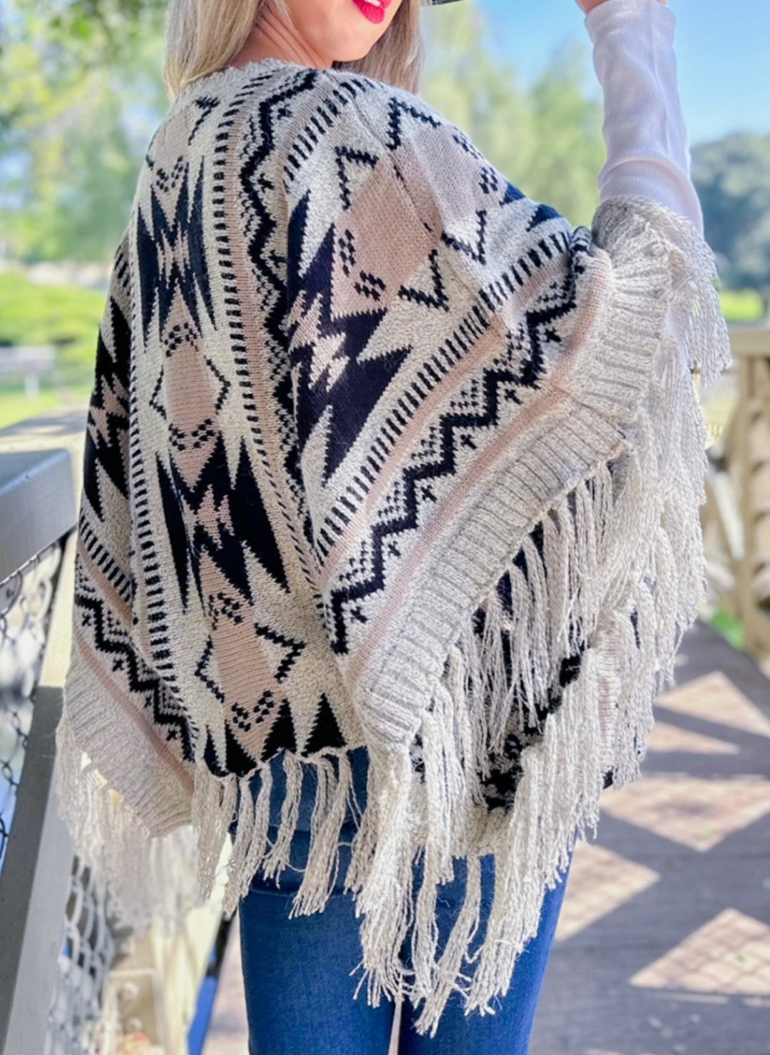 Side view of model wearing Prairie Moon Knit Tassel Top.