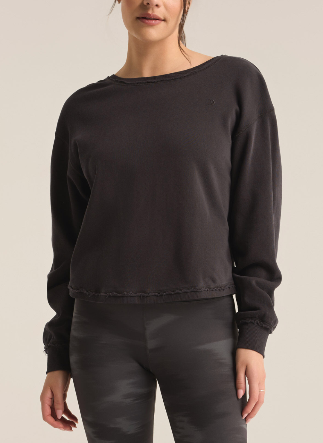 Model is wearing a black sweatshirt, with a slight distressed look around the edges.