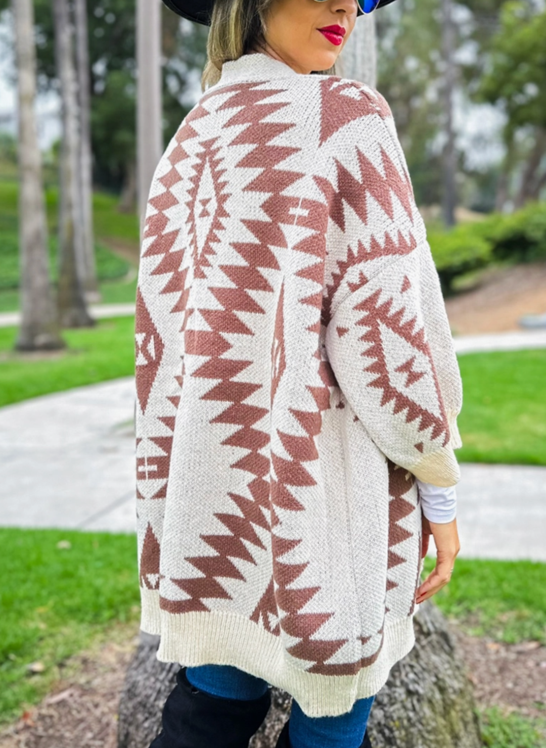Back view of southwestern printed cardigan. Model is turned around to show the detailed print on the cardigan.