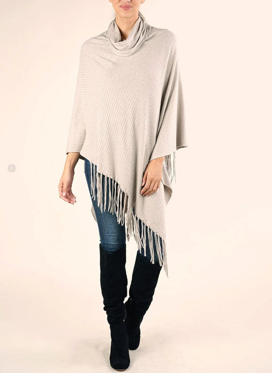 Lovestitch Cowl Neck Baby Cable Poncho with Fringe in beige, front view styled with jeans and boots