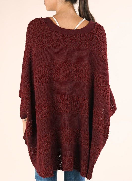 Back view of Lovestitch Popcorn Striped Poncho showing textured knit and relaxed fit.