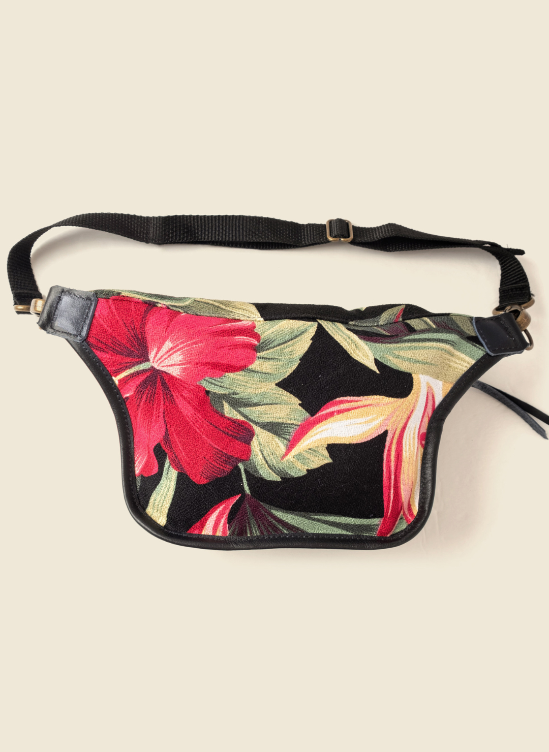 Casupo tropical upcycled canvas and leather fanny pack with brass hardware and adjustable black strap; handmade in Los Angeles with sustainable materials.