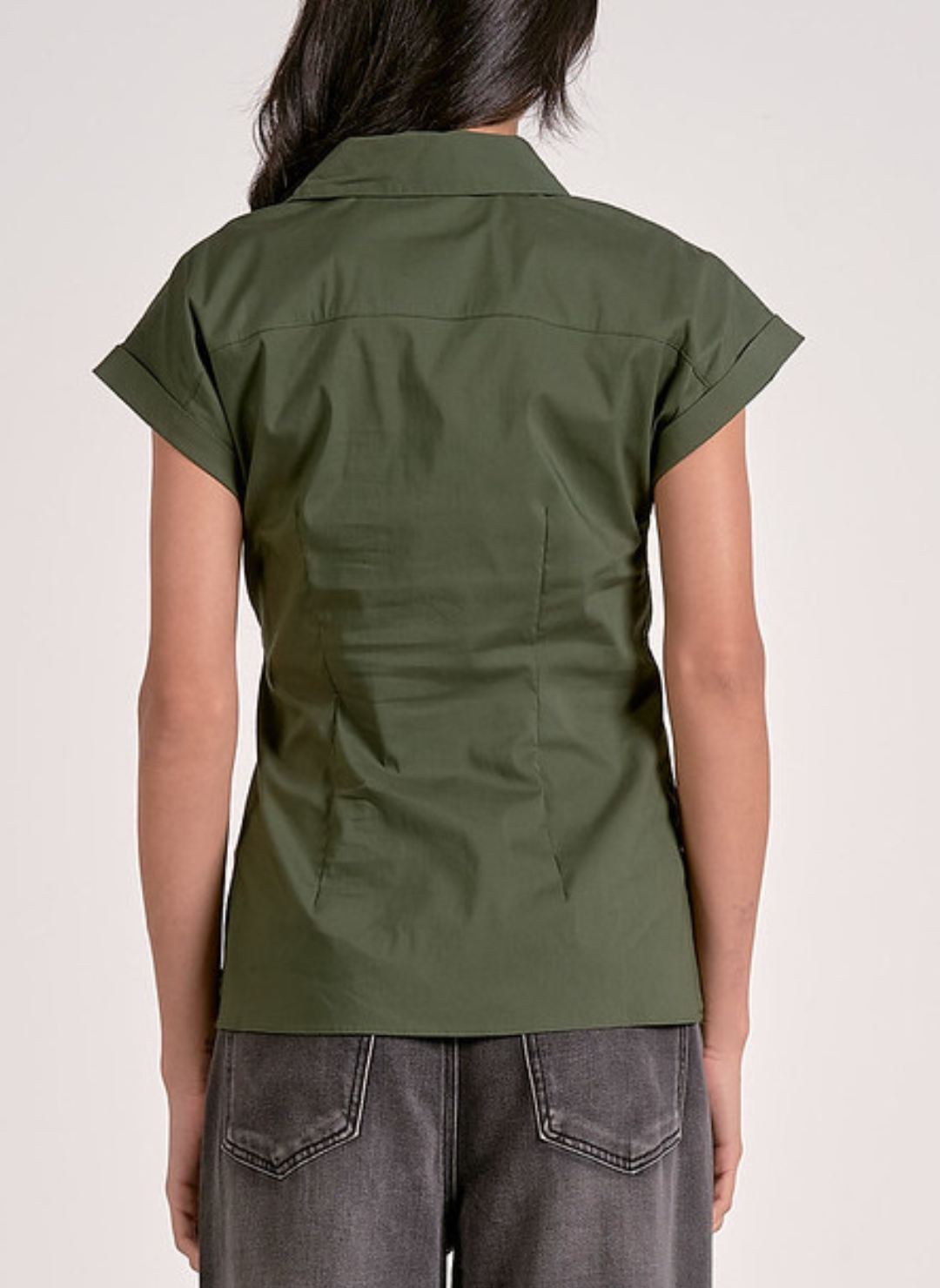 Olive green short-sleeve button-up blouse with a collared neckline, front tie waist detail, and tailored fit, styled with dark wash jeans for a chic casual look.