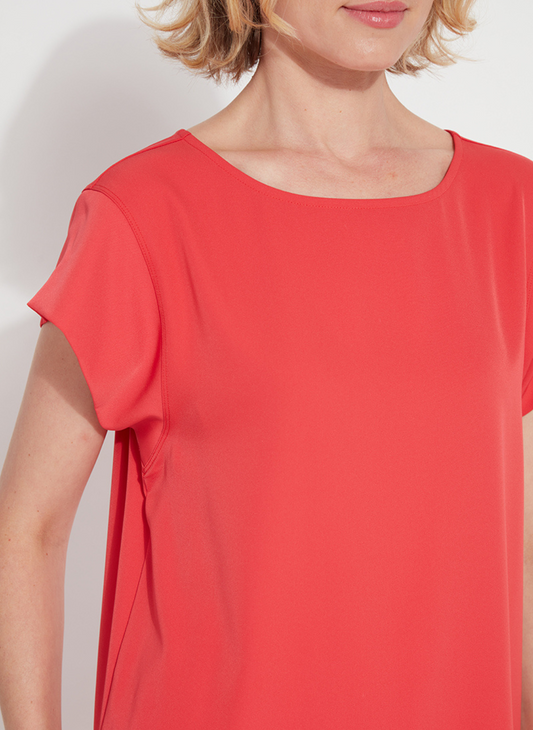 Woman wearing the Melodie Top in Coral Bloom from August Boutique Ripon; features flutter sleeves, scoop neckline, flowy drape, and keyhole back detail. Lightweight and perfect for warm-weather styling.