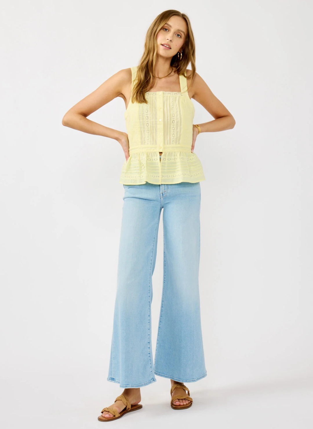 Front and back views of the Lovestitch Boardwalk Eyelet Ruffle Top in light yellow cotton with wide straps, button front, eyelet lace detailing, and ruffled peplum hem, available at August Boutique Ripon.