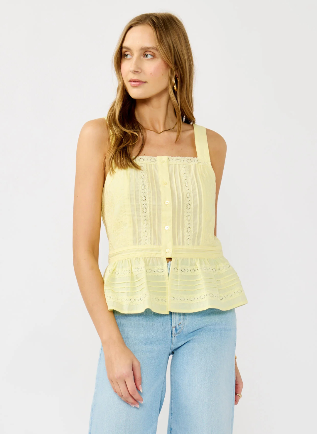 Front and back views of the Lovestitch Boardwalk Eyelet Ruffle Top in light yellow cotton with wide straps, button front, eyelet lace detailing, and ruffled peplum hem, available at August Boutique Ripon.