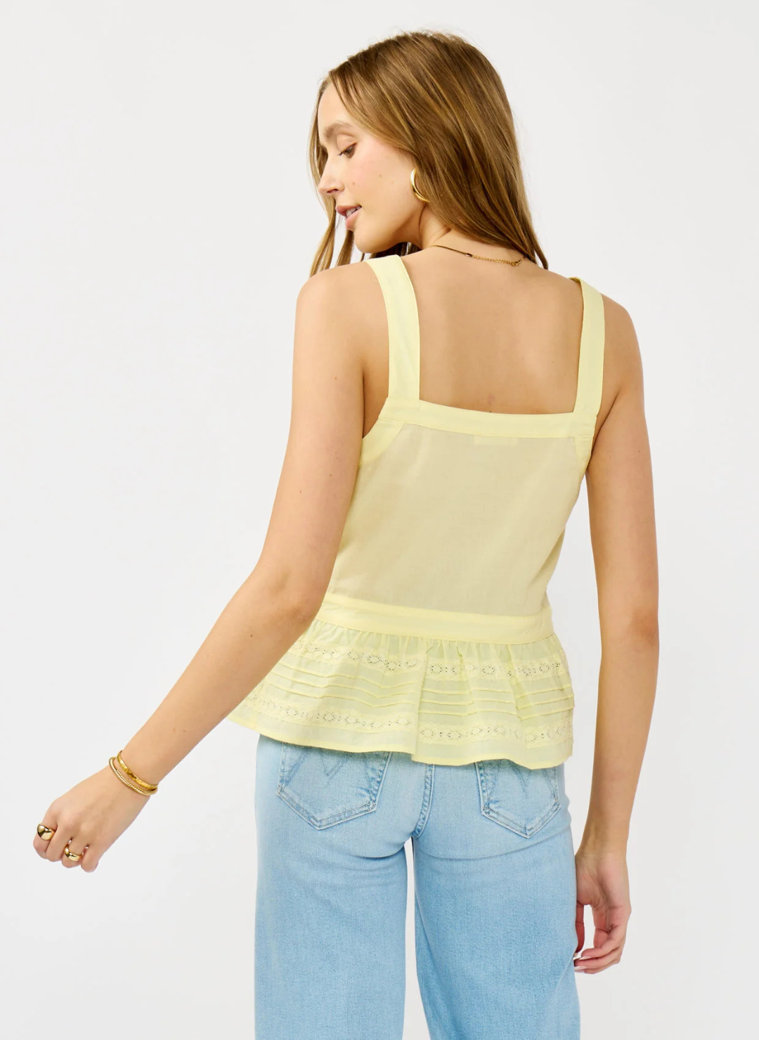 Front and back views of the Lovestitch Boardwalk Eyelet Ruffle Top in light yellow cotton with wide straps, button front, eyelet lace detailing, and ruffled peplum hem, available at August Boutique Ripon.