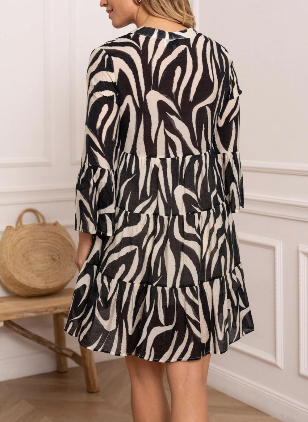 Back view of model wearing black and white St. Tropez Printed Silk Dress. Models hands by her side.