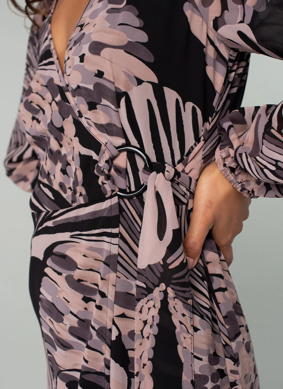 Model is posing with hand on hip, image is zoomed in on the black belt loop.