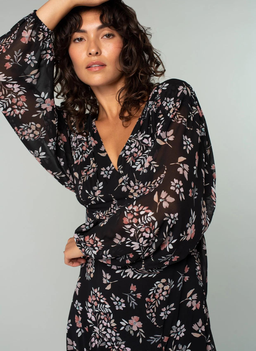 Model is posing with arm over head, showing the V-neck line !
