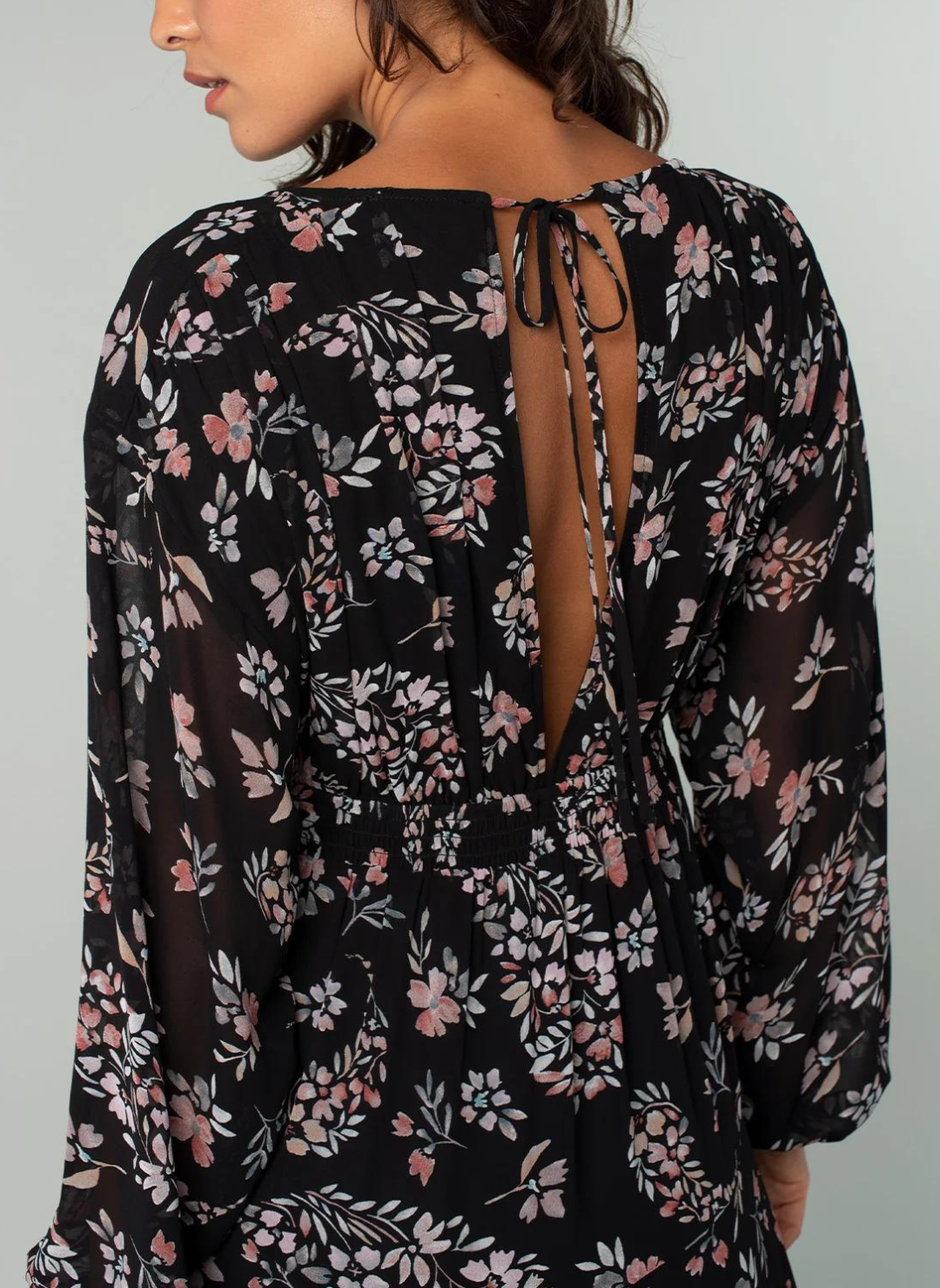 image is zoomed in on the opening of the top with the tie of the back of the dress.