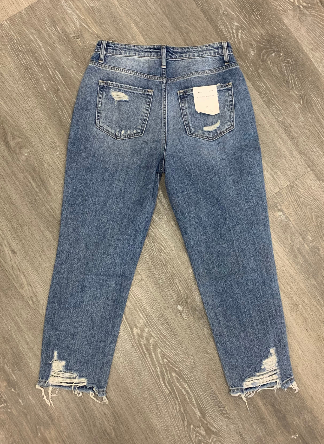 Back view of the FM Distressed Mom Jeans , shows the holes and the pockets of the jeans