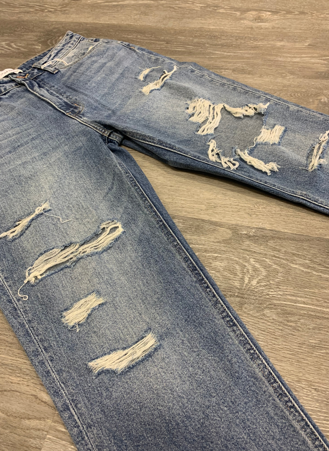 side view of the FM Distressed Mom Jeans highlighting the texture of the jeans and holes.