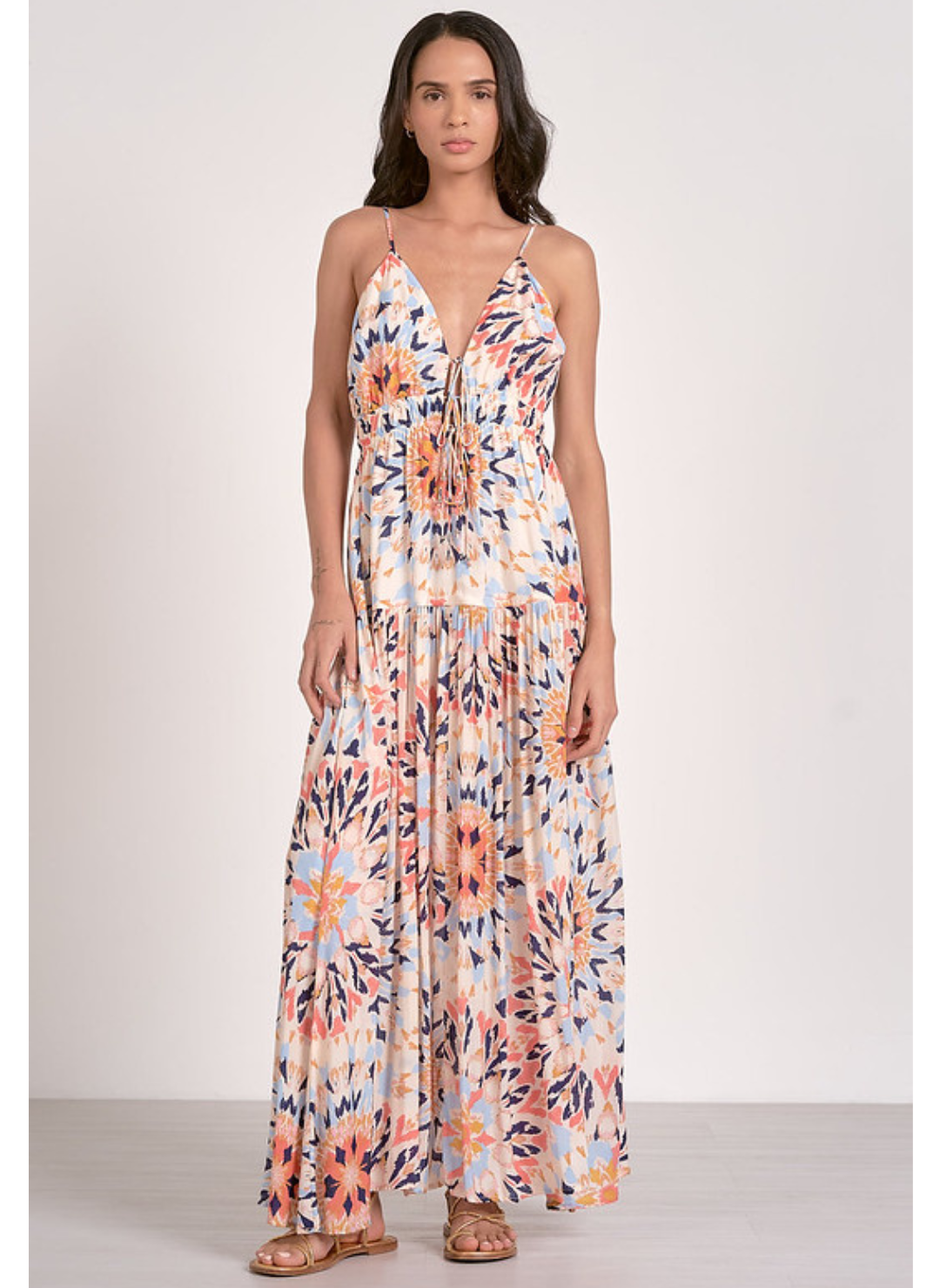 Boho multi-color maxi dress with tie front and smocked waist, adjustable straps, and bold sunset-inspired print – available at August Boutique Ripon.