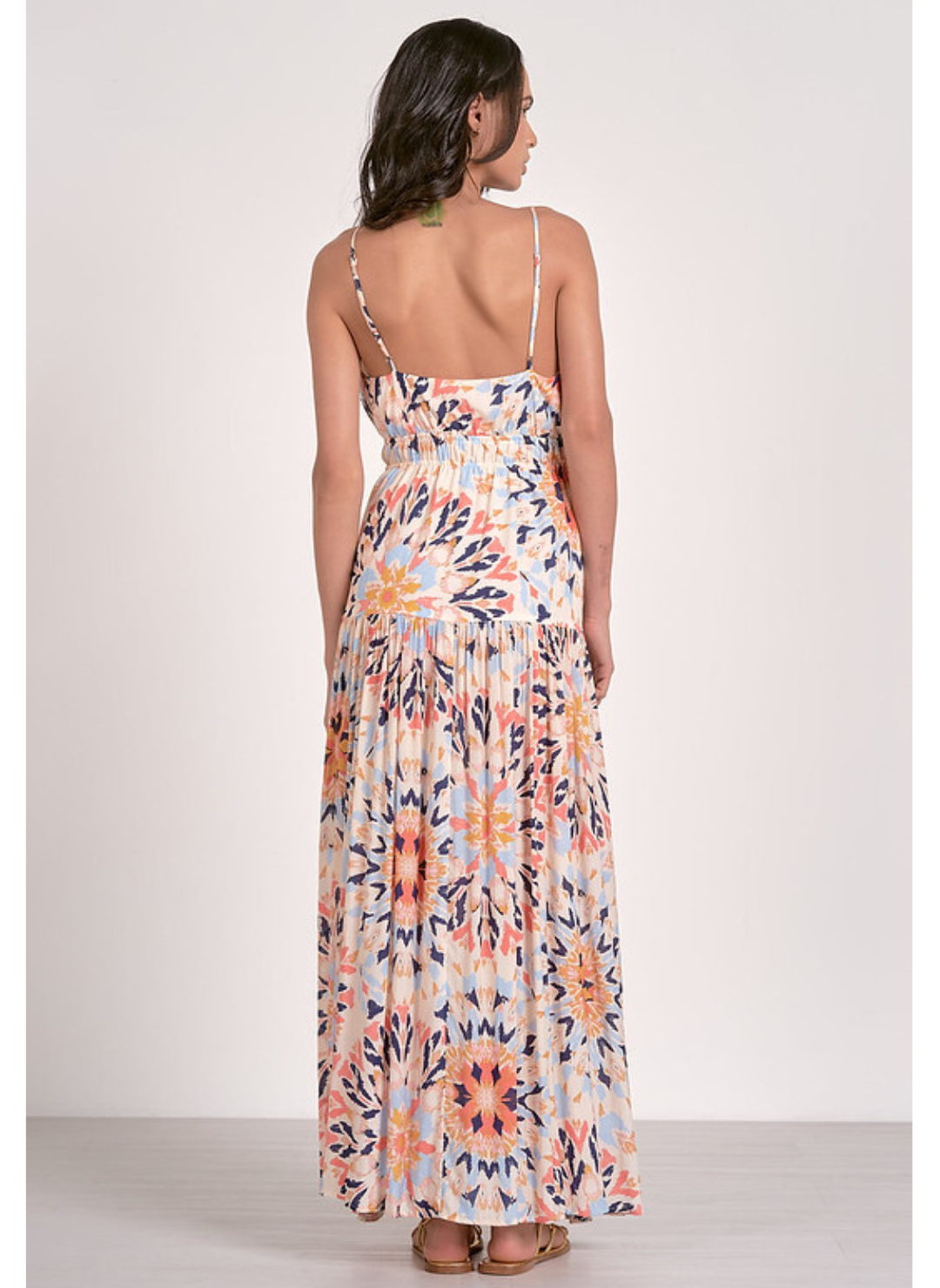 Boho multi-color maxi dress with tie front and smocked waist, adjustable straps, and bold sunset-inspired print – available at August Boutique Ripon.