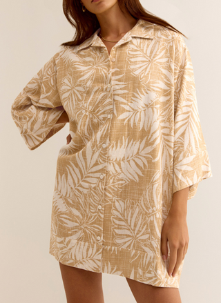 Model wearing golden Palm Dress with front buttons, 3/4 sleeves, and collared neckline.