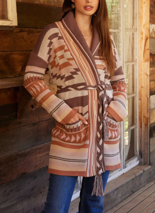 Front view of the model wearing the LS Southwest Suzie Cardigan. Showing off the pockets of the cardigan and the different patterns and texture of the cardigan.