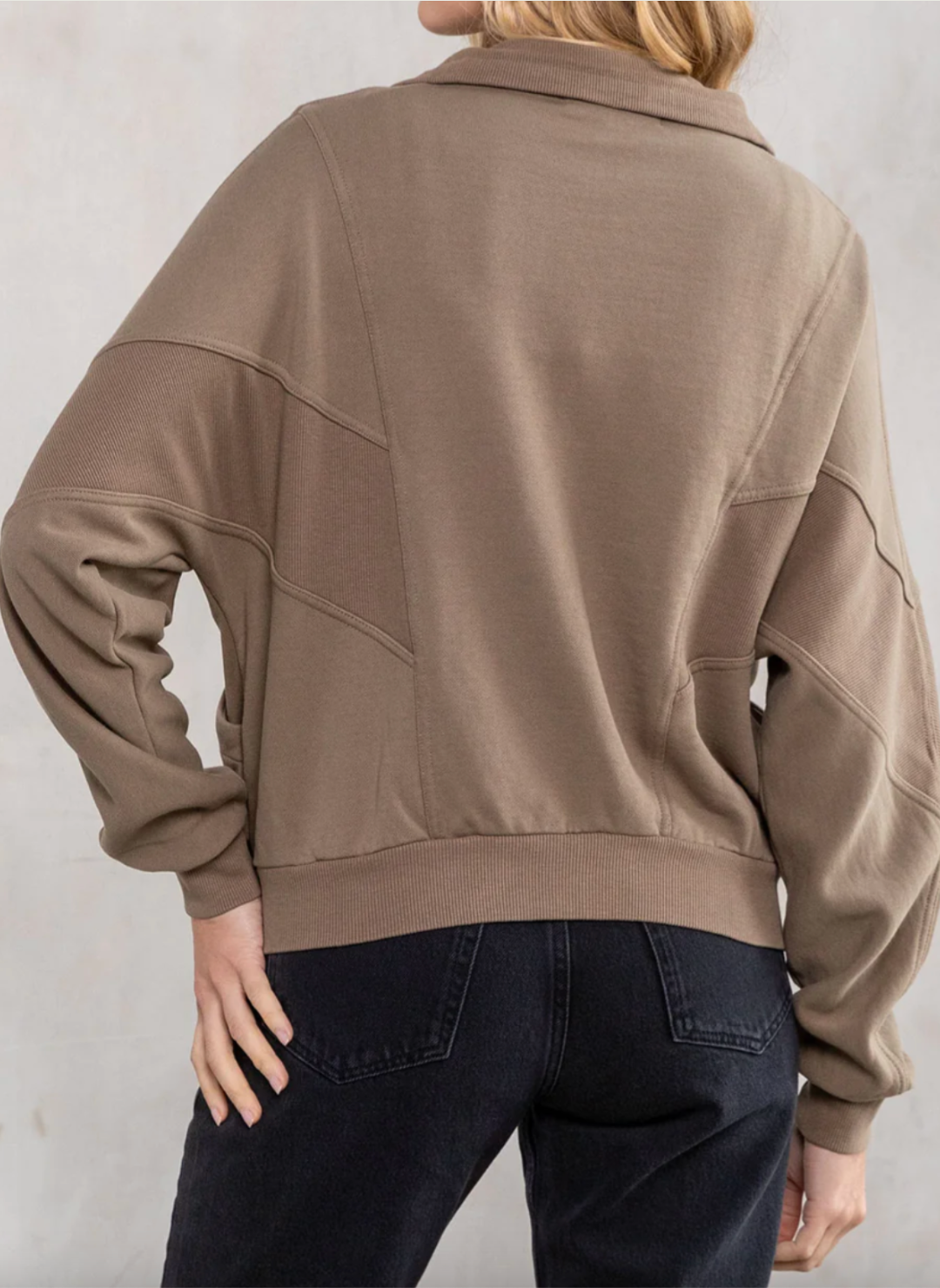 Back view of the model wearing the LS Vivian Vintage Wash Zip Ip Sweatshirt. Showing the pattern and different textures of the sweatshirt.
