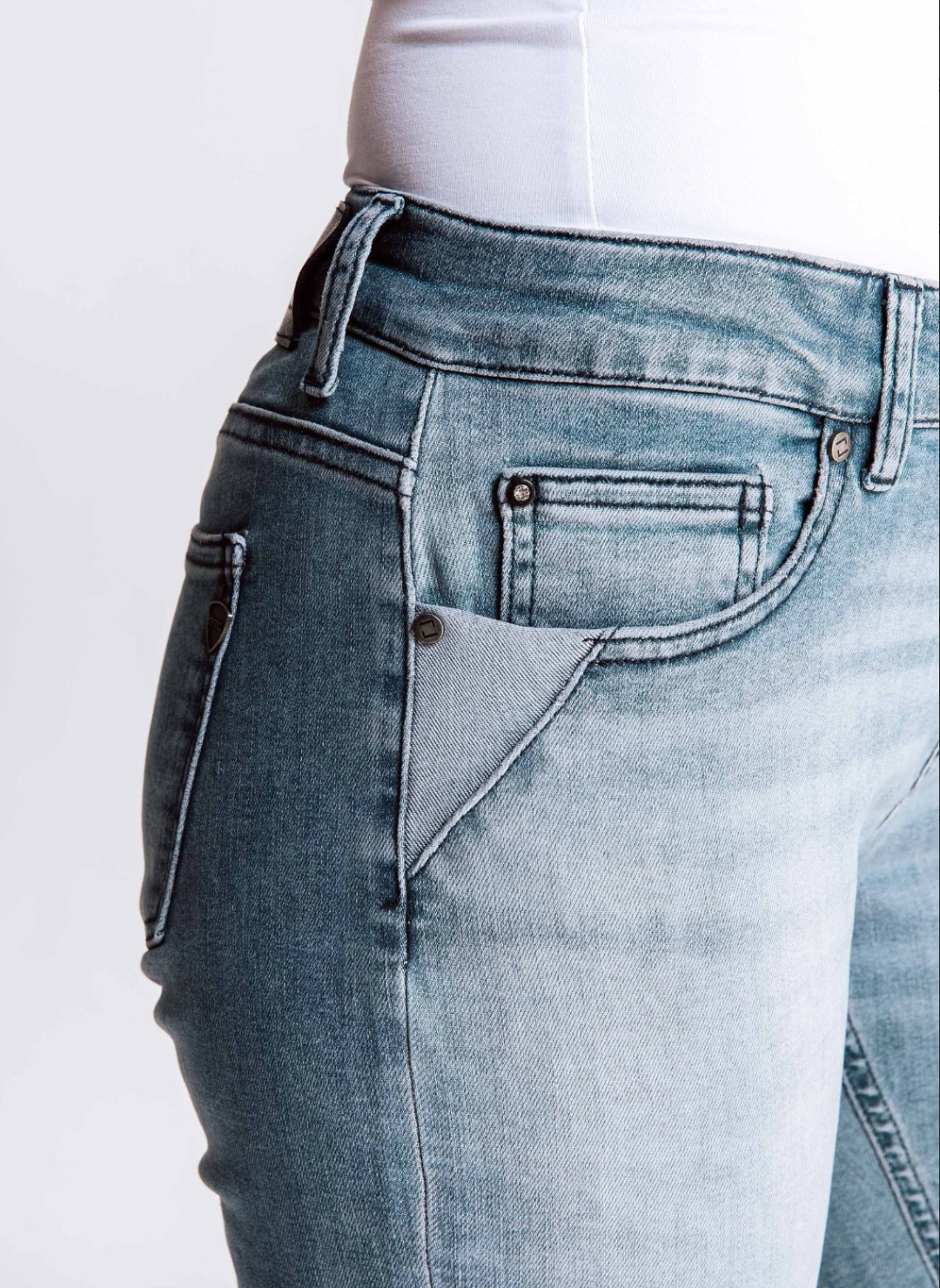 Up close view of the pocket on the ZHRILL Nova Jean that the model is wearing. Model is also wearing a white top. White background. 