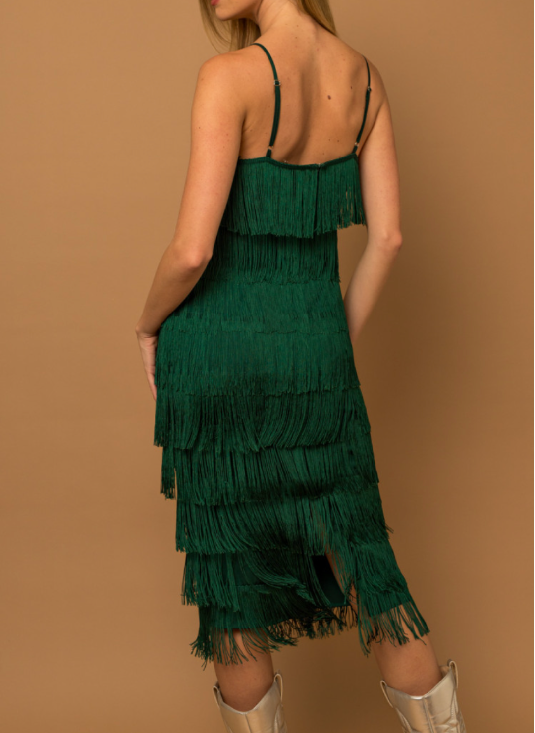 Back view of model wearing Gi Fringe Strap Dress with vibrant green color and fun fringe.