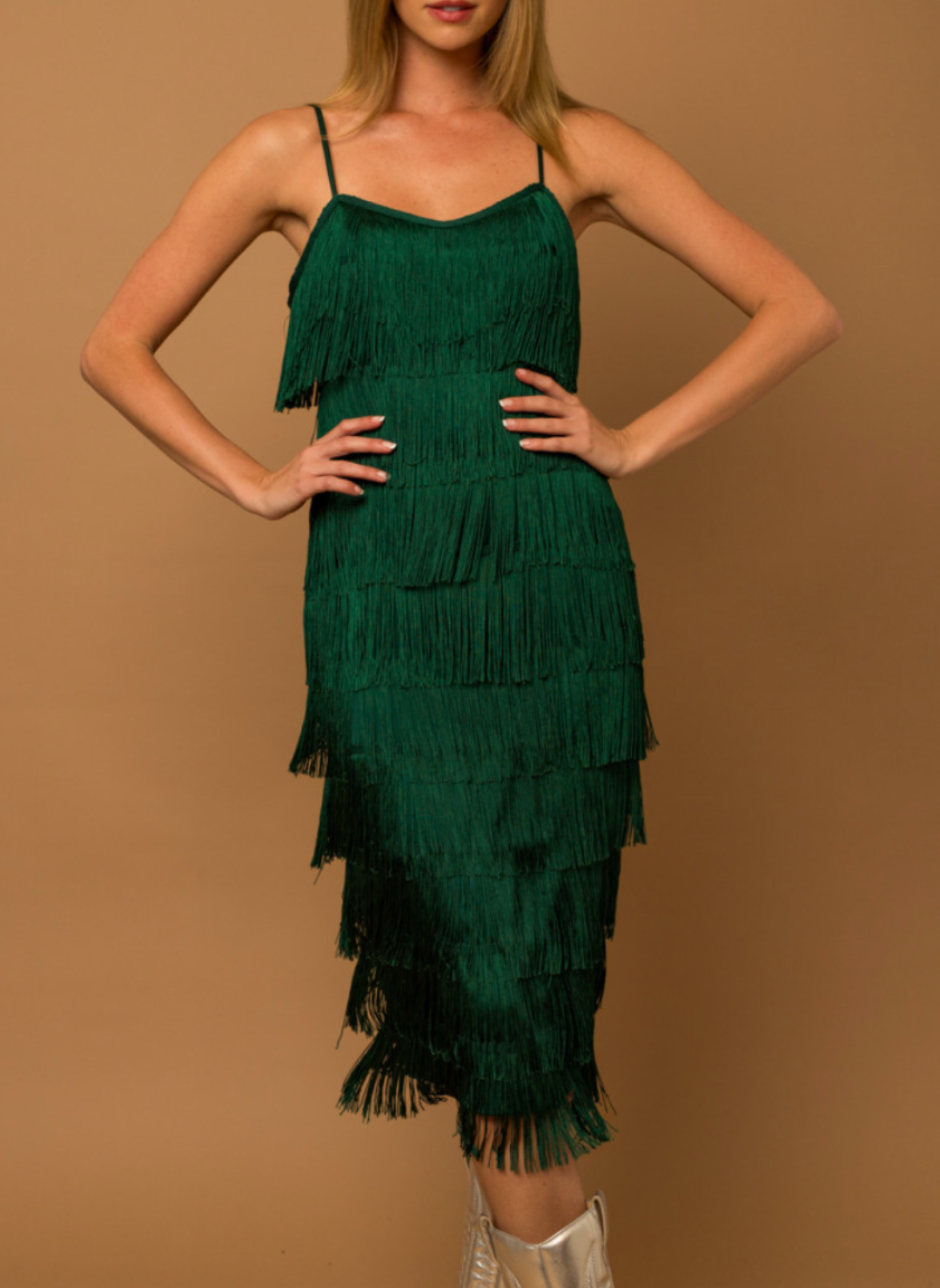 Model has hands on hips wearing Gi Fringe Strap Dress with vibrant green color and fun fringe.