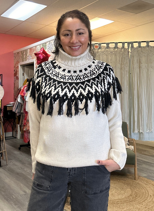 Front view of the model wearing the LS Frida Fringe Fairisle Sweater. Showing the texture of the knit sweater and the fringe on the front.