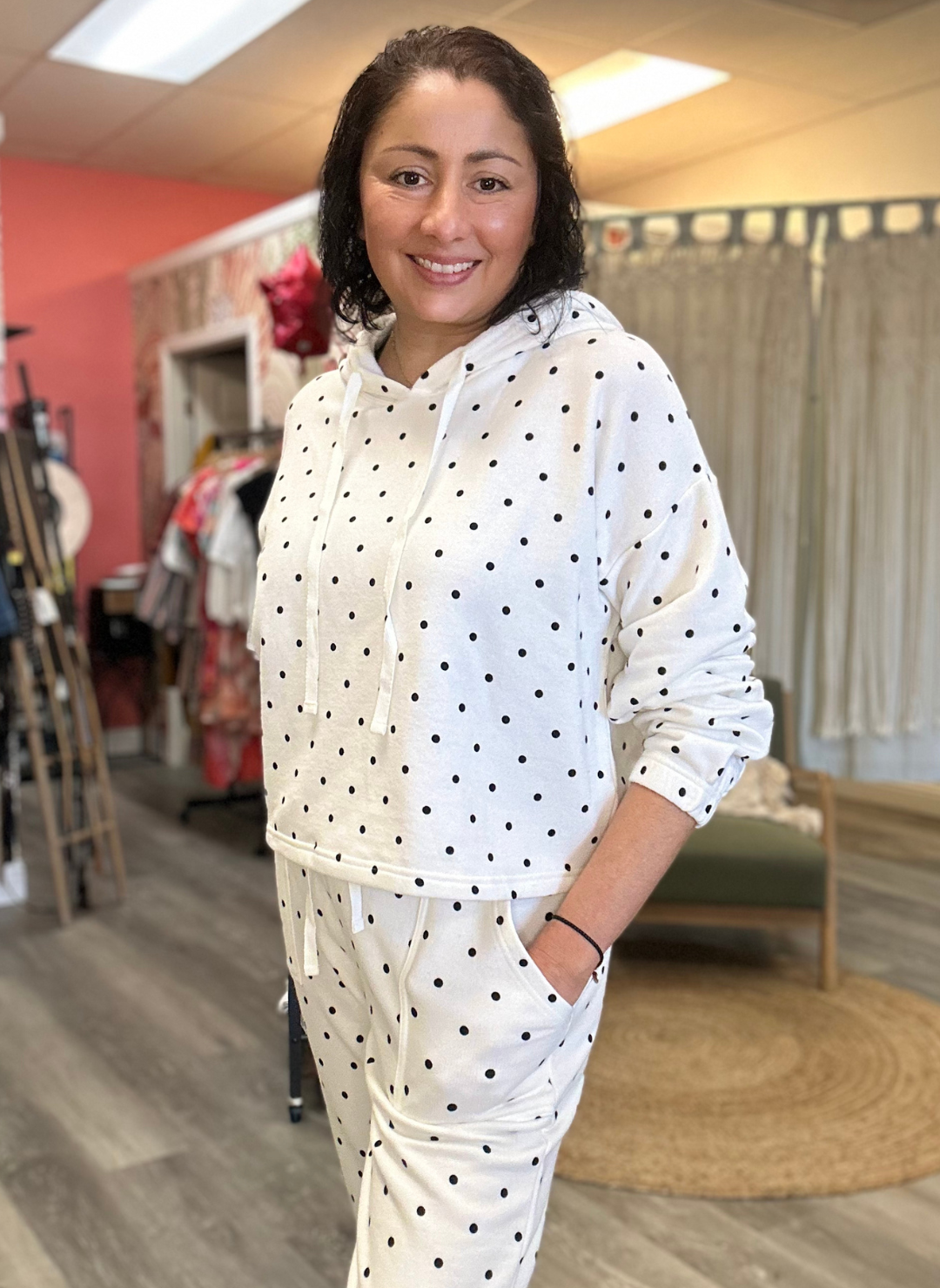 Front view of the model wearing the LS Polka Dot Princess Pullover and Pants. Showing the pockets on the pants and strings on the pullover. Then pushing the sleeve to her elbow showing texture.