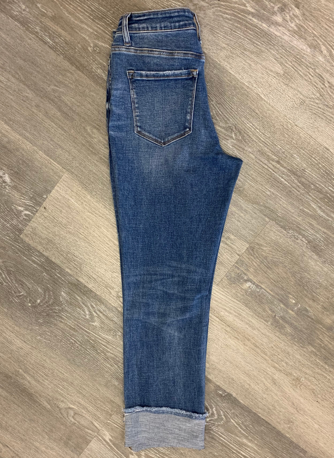 One side view of the back side of the Helen High Rise Regular Straight Leg jeans showing off the pocket and cuff of the jean.