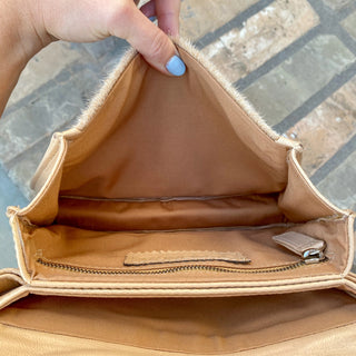 View of the inside of the purse and pockets with zipper.