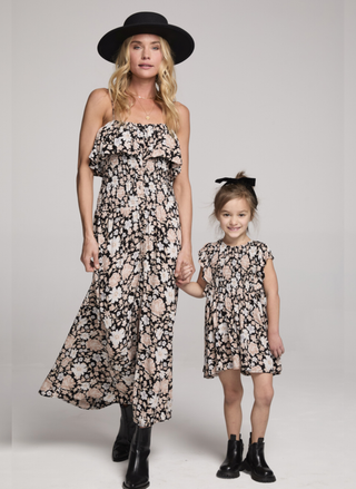 Front view of Saltwater Luxe Mirabelle Midi Dress in black floral print featuring ruffled strapless neckline and flowing silhouette