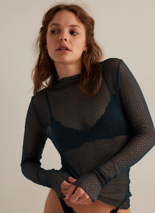 Front view of Free People Minding My Business Mesh Top in green featuring sheer long sleeves and stretchy fit