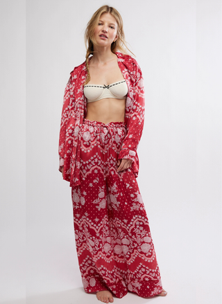 Woman wearing a red floral kimono-style outfit on a white background