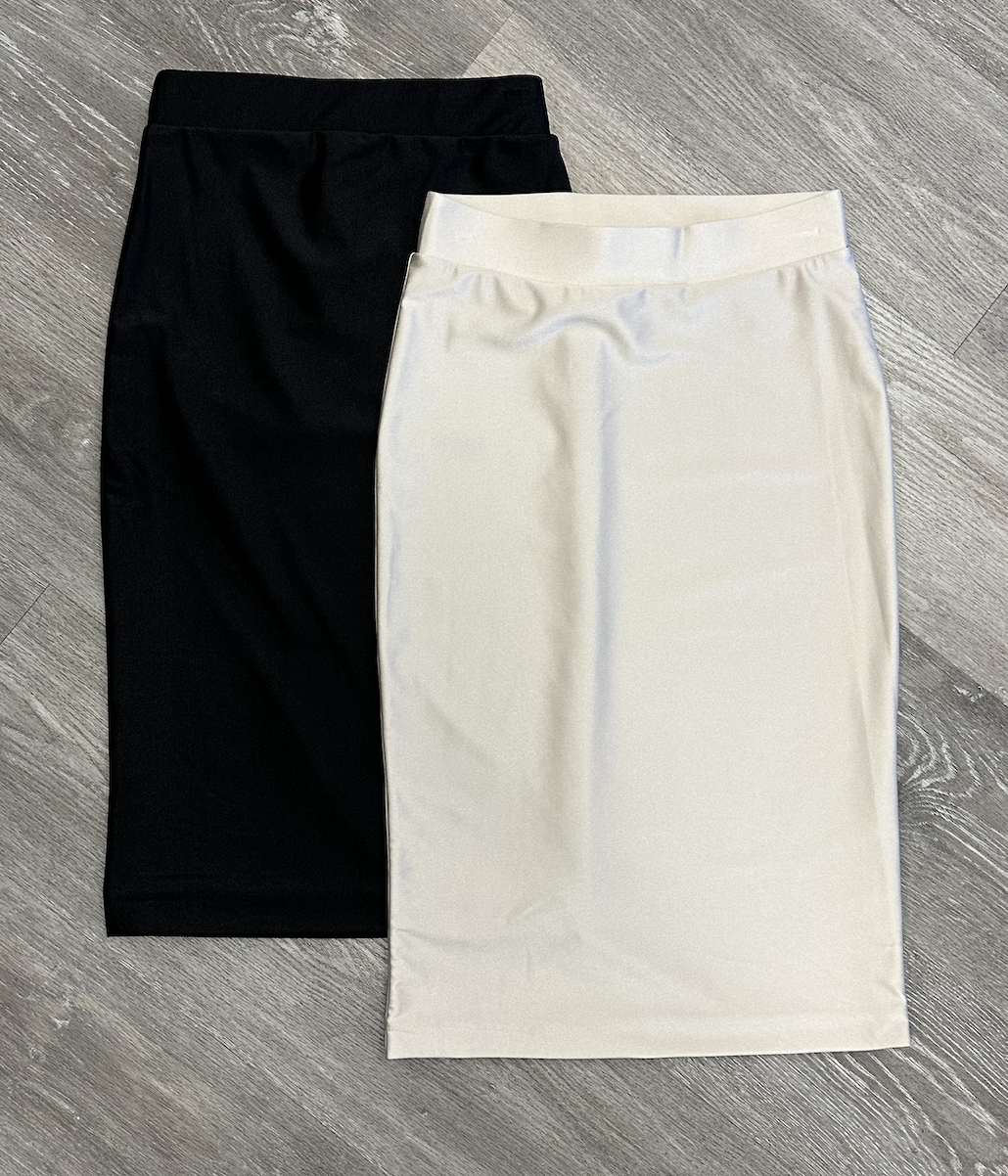 Black and white skirts on a gray wooden surface