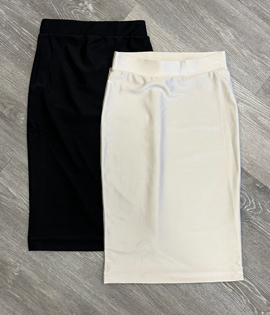 Black and white skirts on a gray wooden surface