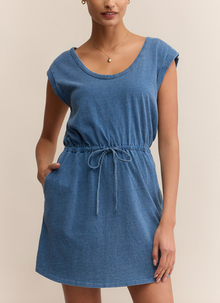 This image features the Z Supply Dayshift Denim Mini Dress, a stylish and versatile piece suitable for various occasions. The dress is crafted from a lightweight denim material, presenting a washed blue finish that adds to its casual yet chic appeal.