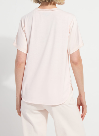 Back view of Lyssé pink top showing 4-way stretch rayon jersey back panel and high-low rounded hem