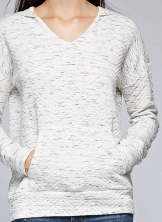 Close-up detail of quilted cotton-rayon fabric texture and kangaroo pocket on Lovestitch hoodie in gray