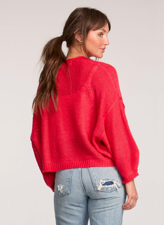 Back view of Saltwater Luxe red cardigan showing relaxed boxy fit.