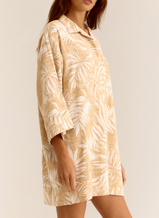 Side view of model wearing golden Palm Dress with front buttons, 3/4 sleeves, and collared neckline.