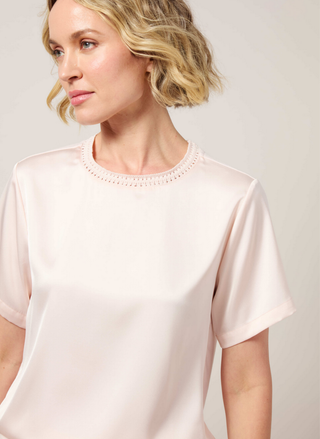 Close-up detail of hand-crocheted pointelle collar band and soft touch satin fabric on Lyssé Jenika top