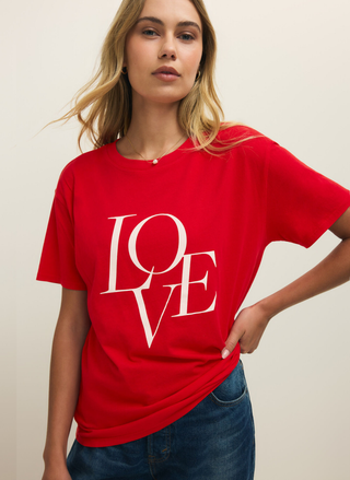 Woman wearing a red t-shirt with 'LOVE' printed on it against a plain background