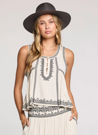 Model wearing the Saltwater Luxe Quinley Embroidered Tank in cream with black embroidery, styled with the matching embroidered skirt and a wide-brim hat for a boho-chic summer look.